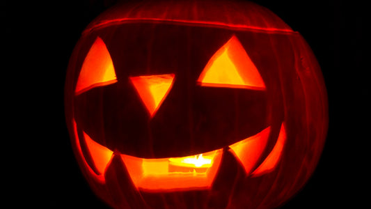 A glowing carved jack-o'-lantern in the dark