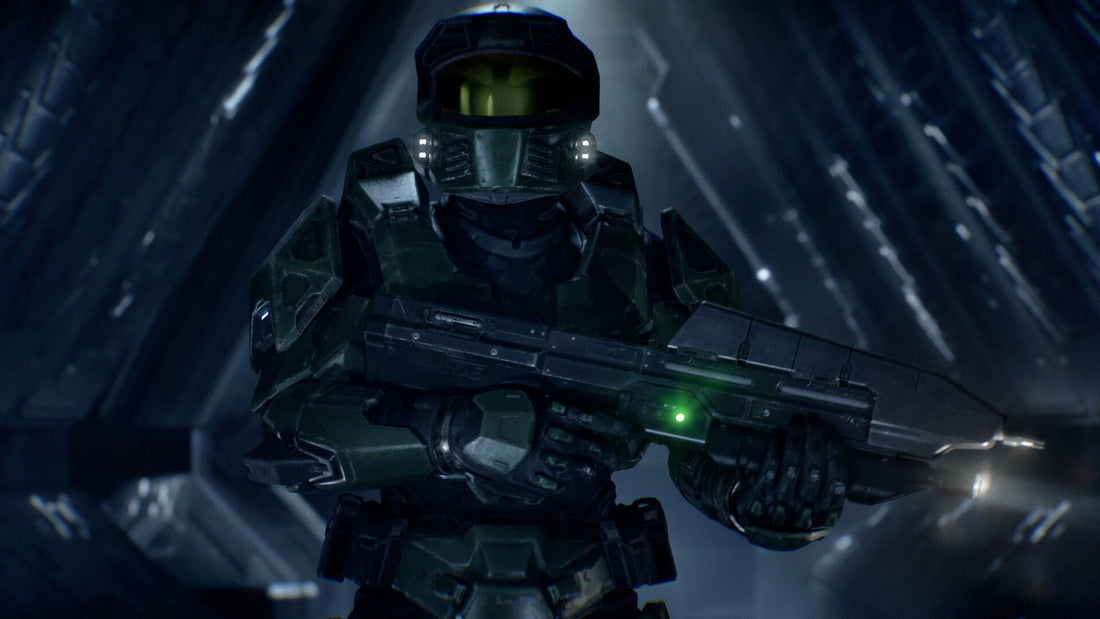 Master Chief holding an assault rifle in a dim blue corridor in Halo: Campaign Evolved