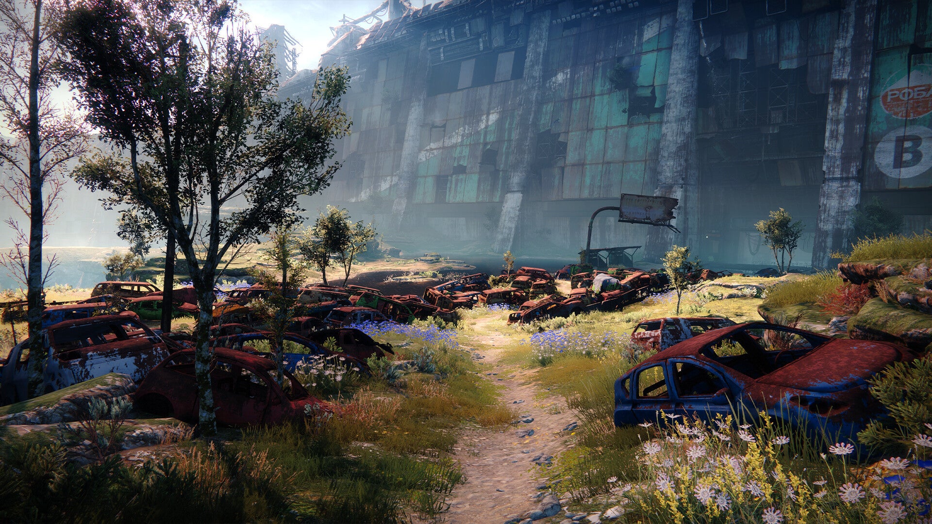 A Guardian walks along a forest path past rusted cars in Destiny 2