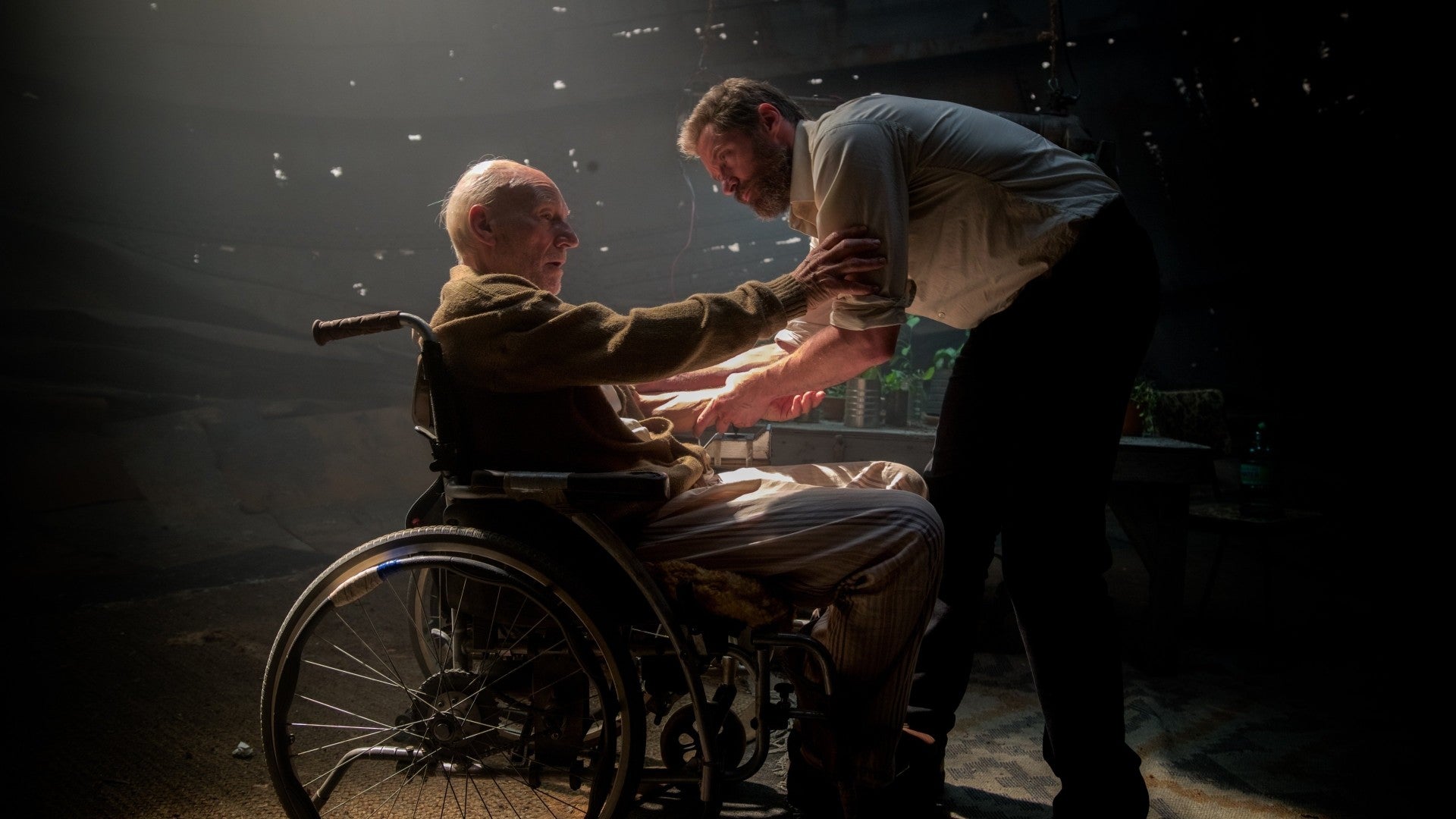 Logan helps Charles Xavier in his wheelchair in Logan