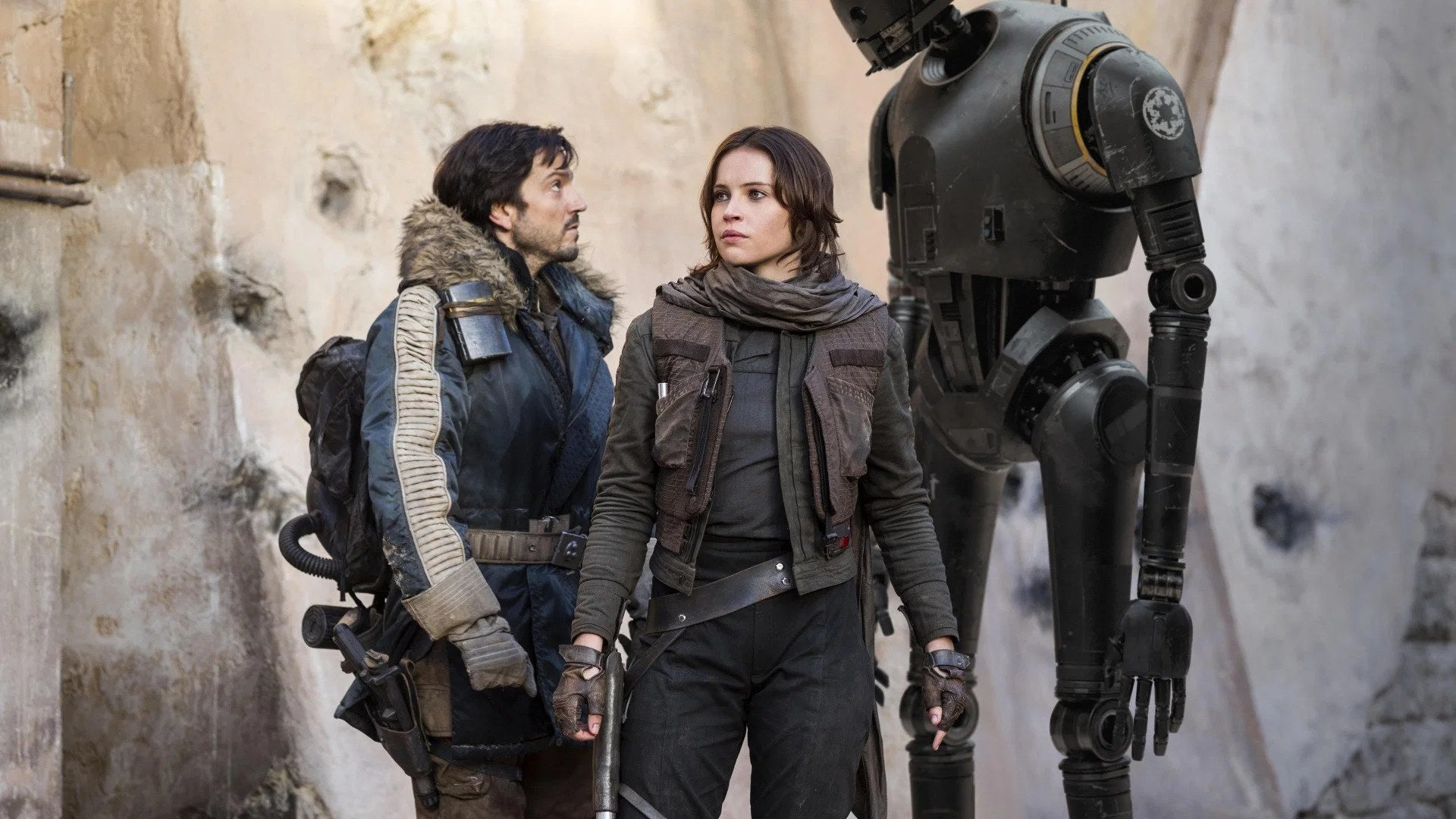 Cassian Andor, Jyn Erso and K-2SO stand together in Rogue One